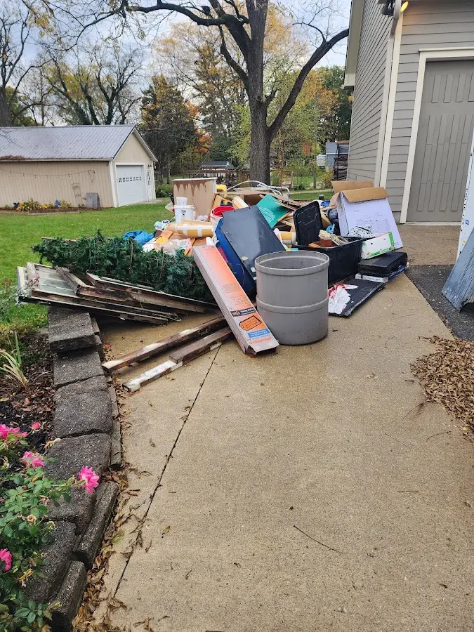 Dumpster being loaded with debris for 3 Yard Dumpster Rental in Munroe Falls